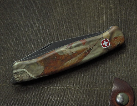 Wenger Ranger 110, or "Serrated Century with Woodsaw" model has Advantage Timber camouflage print scales, and also includes a nice solid removable pocket/belt clip.